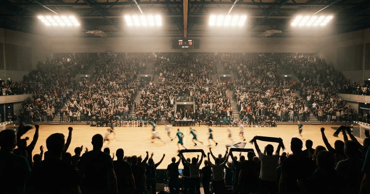 A packed sports hall under floodlights photographed from a long way off